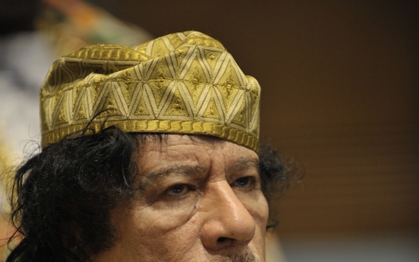 Muammar Gaddafi, leader of the Revolution of the Great Socialist People's Libyan Arab Jamahiriya, Sits Reading in the Plenary Hall of the United Nations (UN) Building in Addis Ababa, Ethiopia, During the 12th African Union (AU) Summit