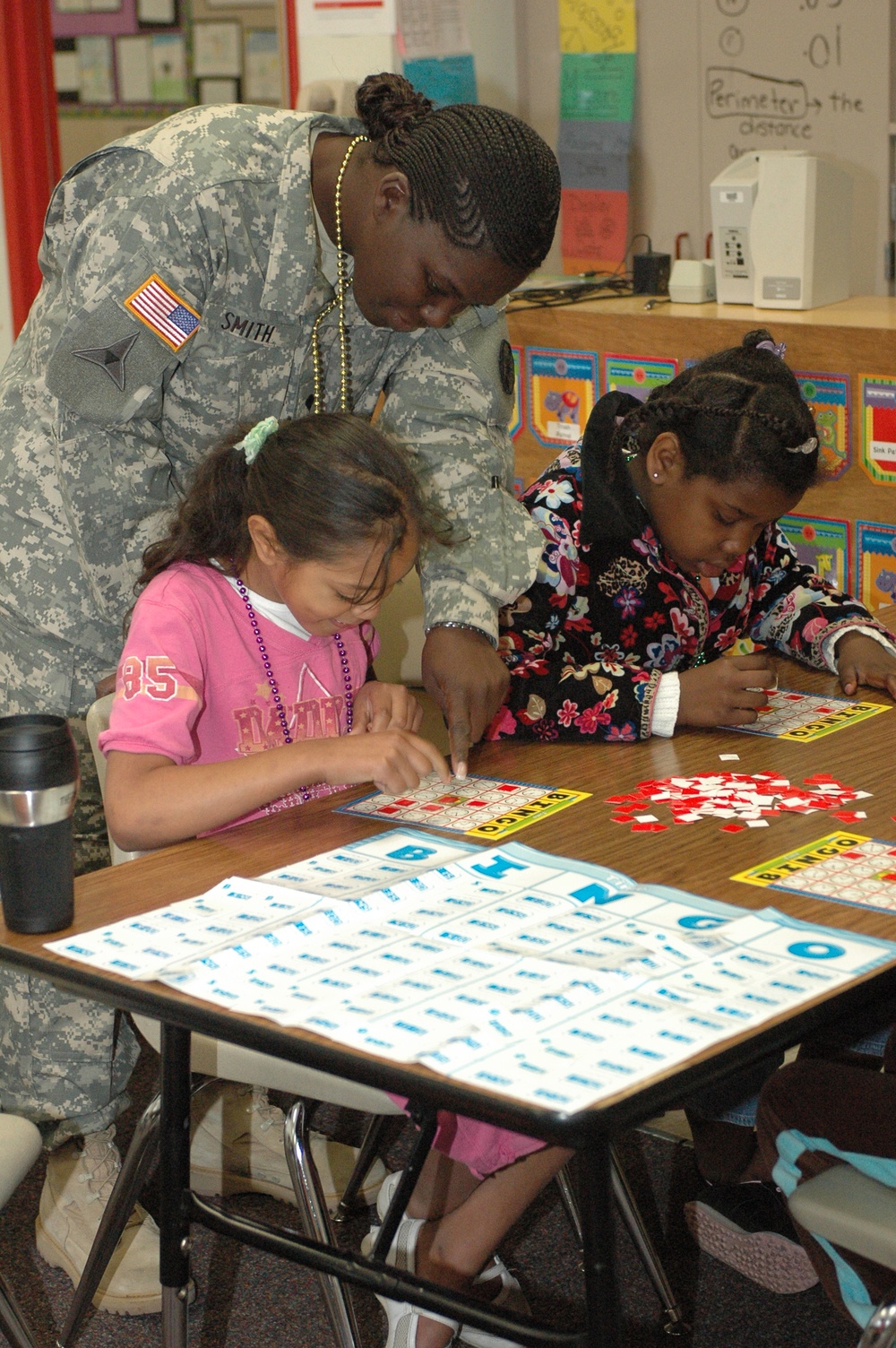 13th Sustainment Command (Expeditionary) Soldiers Help East Ward Elementary Students Study
