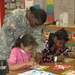 13th Sustainment Command (Expeditionary) Soldiers Help East Ward Elementary Students Study