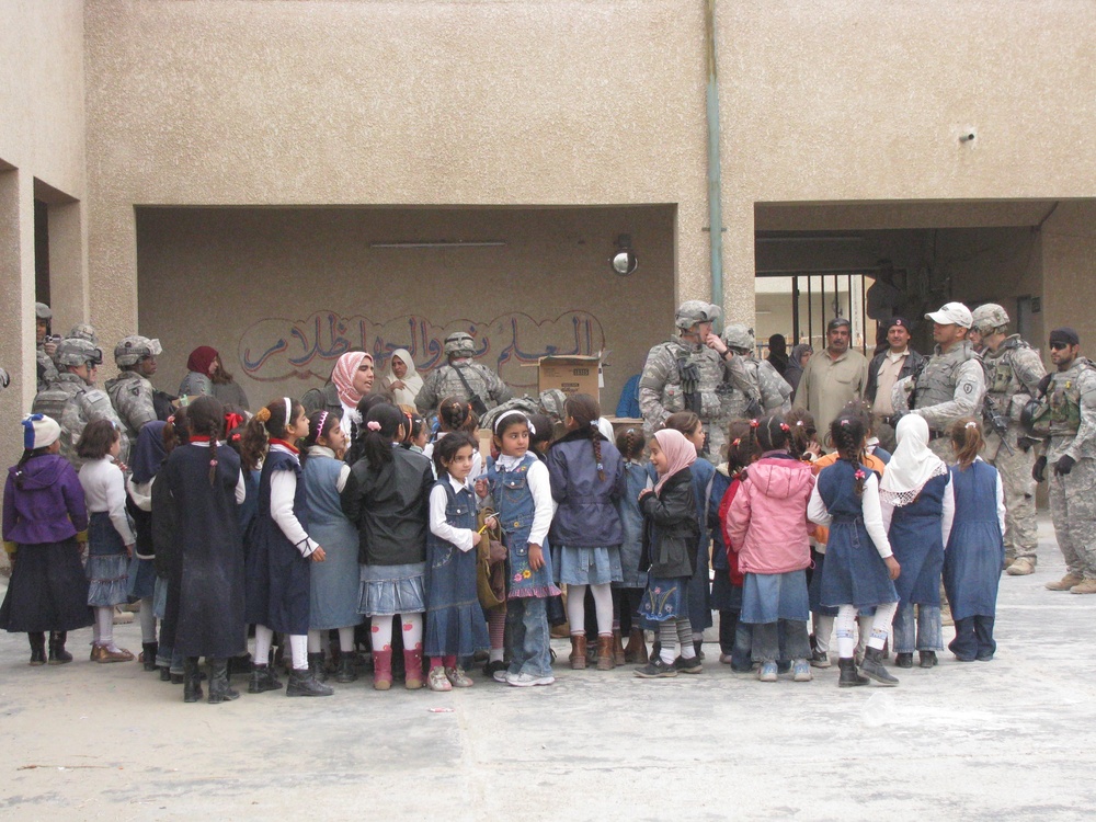 Indiana National Guard Transporters bring caring from home to school in Iraq