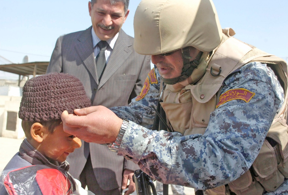 Iraqi Security Forces, Multi-National Division - Baghdad Soldiers distribute supplies to Karada schools