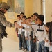 Soldiers, Iraqi national policemen distribute school supplies in Baghdad