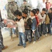 Soldiers, Iraqi national policemen distribute school supplies in Baghdad