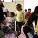 Iraqi army, Iron Brigade Soldiers give clothes, toys to widows in Arab Jabour