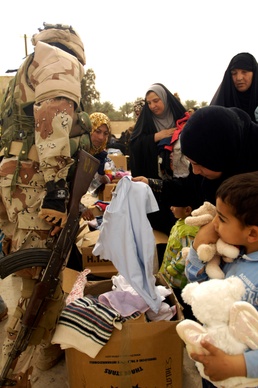 Iraqi army, Iron Brigade Soldiers give clothes, toys to widows in Arab Jabour