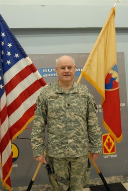 Judge Advocate General exchanges gavel for a pistol