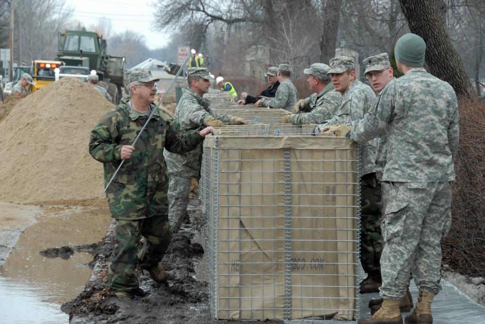 Deployment-hardened Soldiers, Airmen use familiar barriers to dam rising floodwaters