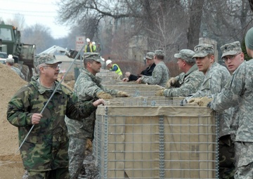 Deployment-hardened Soldiers, Airmen use familiar barriers to dam rising floodwaters