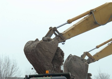 Deployment-hardened Soldiers, Airmen use familiar barriers to dam rising floodwaters