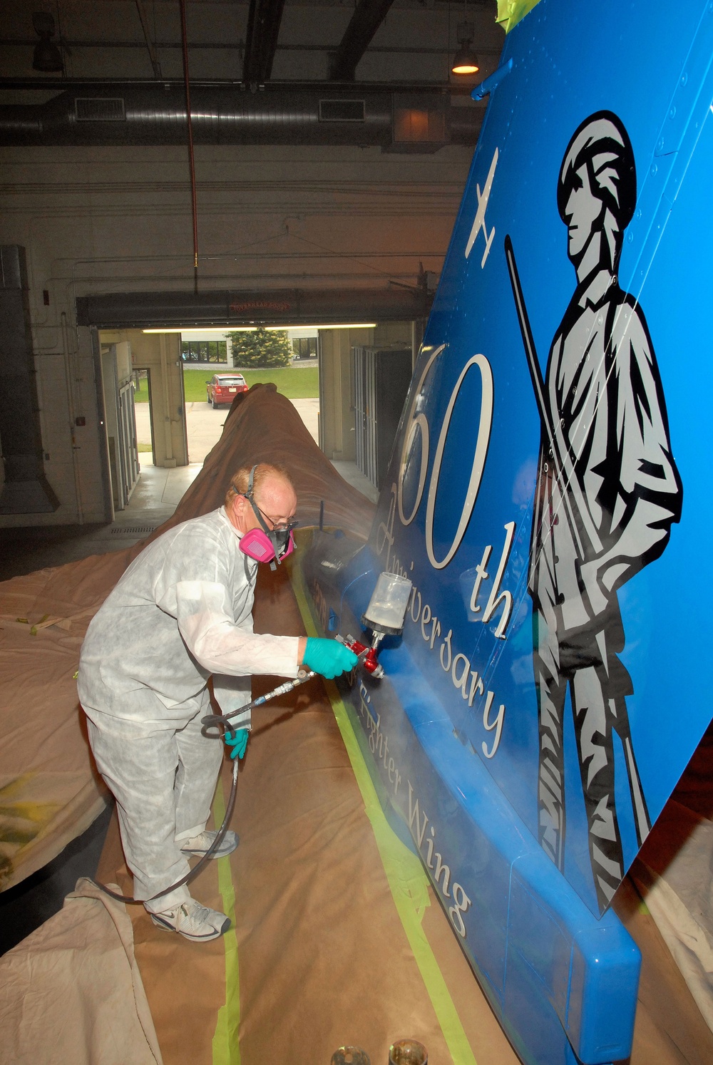Wisconsin Air Guard Craftsman Applies Anniversary Tail Art to F-16