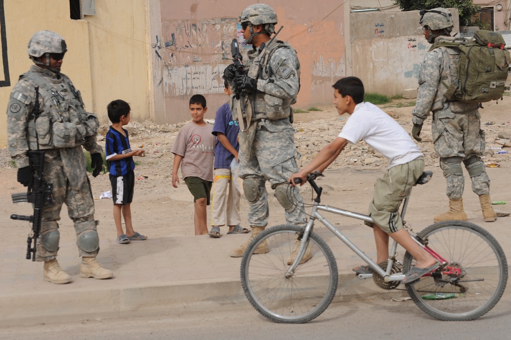 U.S., Iraqi forces patrol through Dora in Baghdad