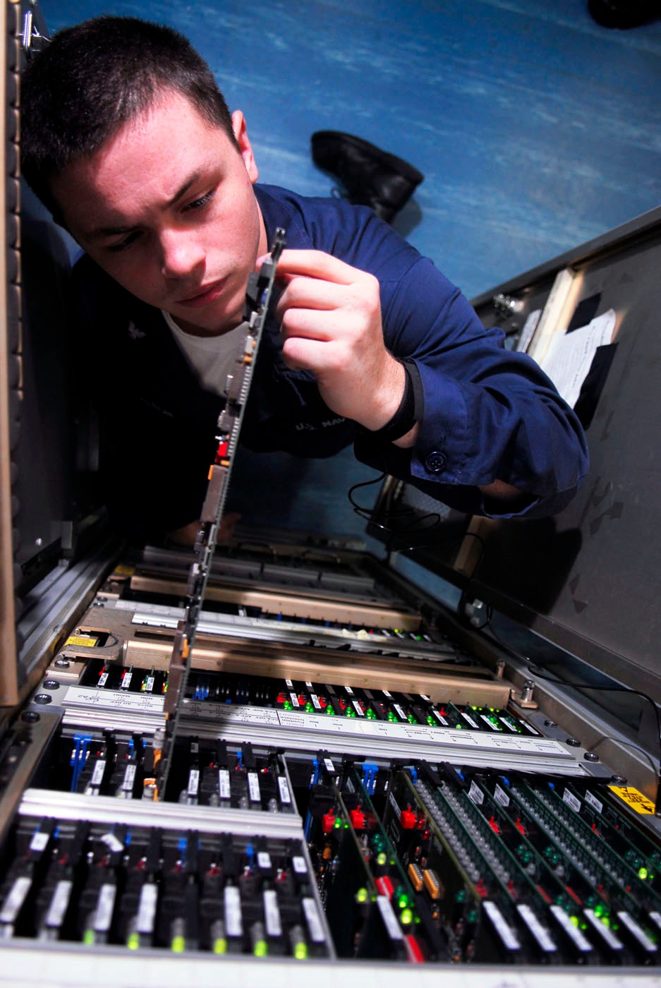 Electronics technician repairs touch entry display interface