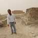 Iraqi security members inspect rocket crater at ancient site
