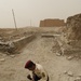 Iraqi security members inspect rocket crater at ancient site