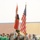 A joint color guard ceremony is taking place on a sports field, featuring both U.S. Army soldiers and Iraqi security forces personnel presenting the flags of Iraq and the United States. The event appears to be associated with a soccer/football event, as players in green uniforms are visible in the background. The setting is a stadium with visible seating stands.