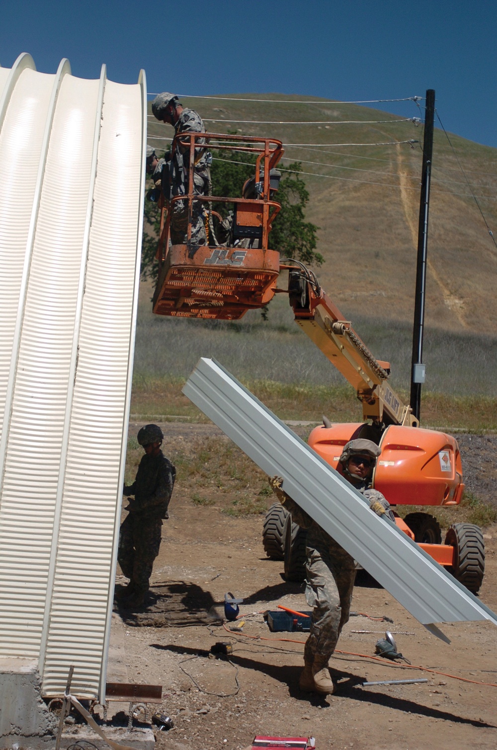 Twelve Dallas Reservists Build Three Steel Barracks in Two Weeks