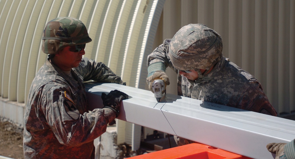 Twelve Dallas Reservists Build Three Steel Barracks in Two Weeks