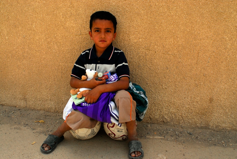 Soccer balls and dolls; Americans make Iraqi children smile