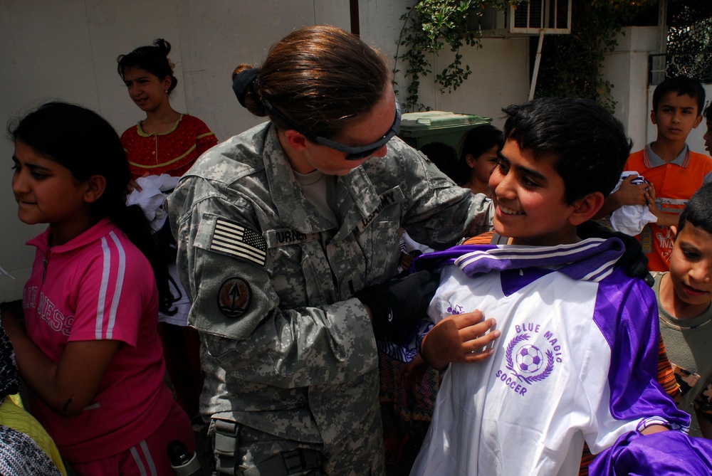 Soccer balls and dolls; Americans make Iraqi children smile