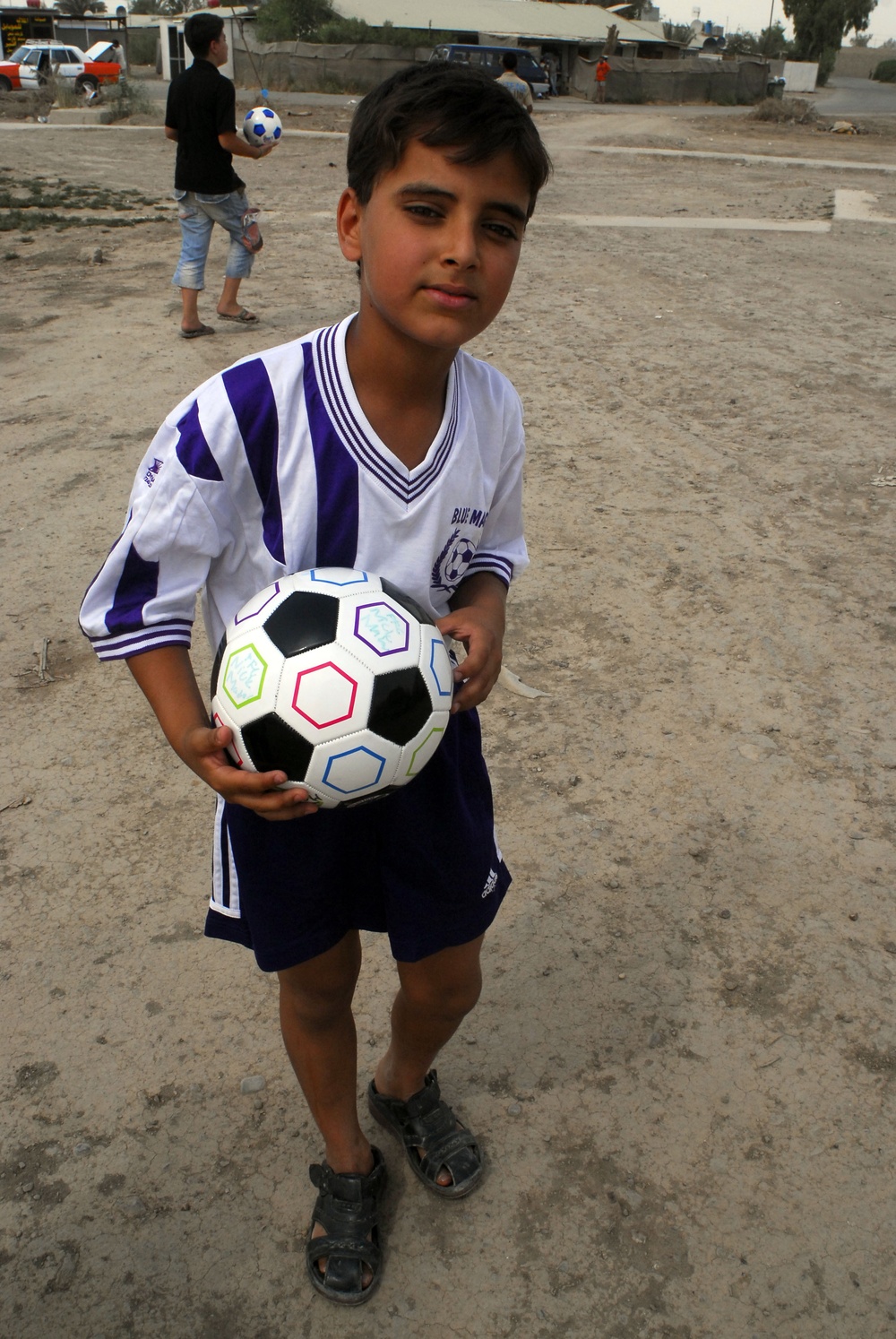 Soccer balls and dolls; Americans make Iraqi children smile