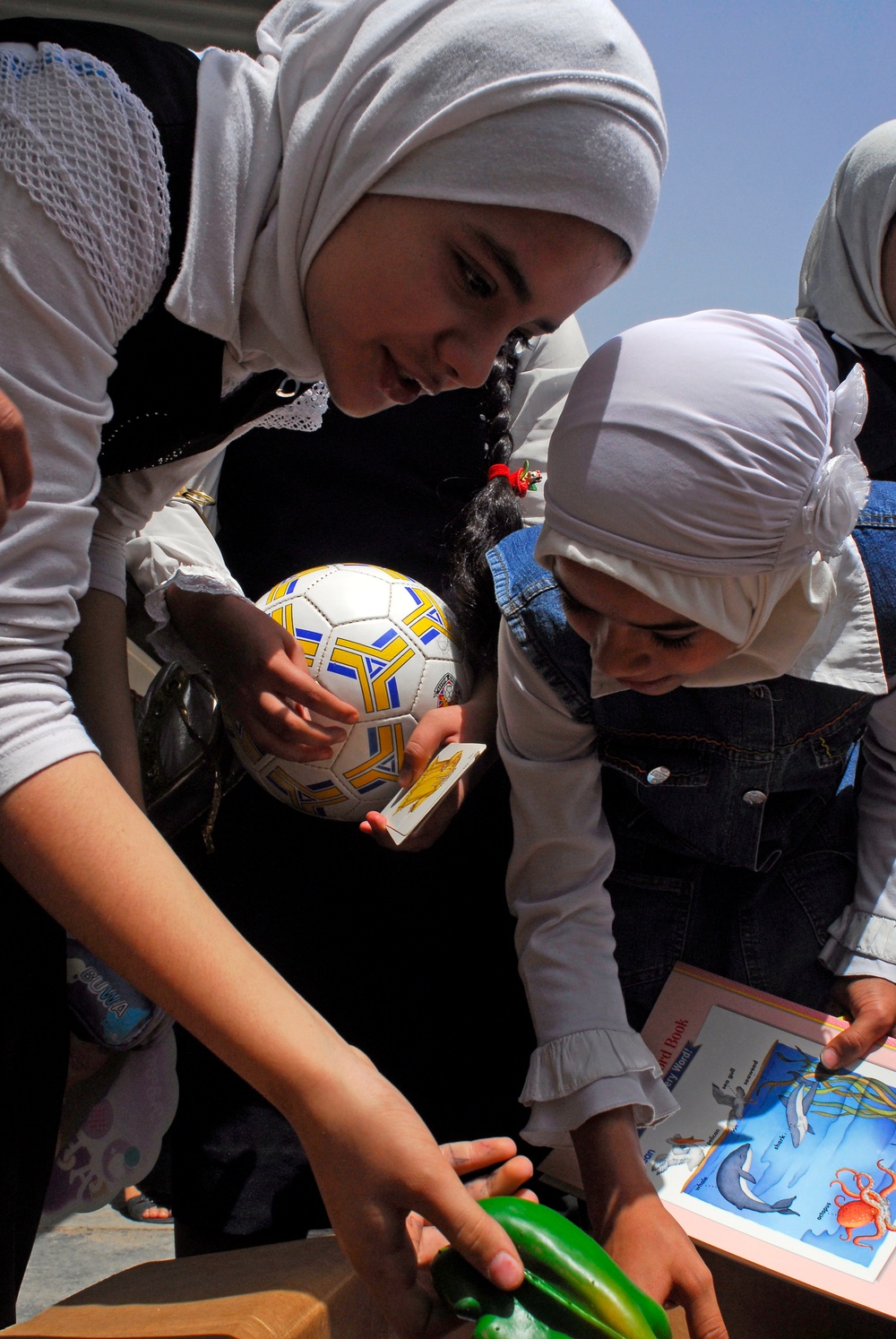 Soccer balls and dolls; Americans make Iraqi children smile