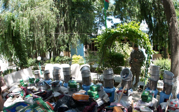 International Security Assistance Force And government of Afghanistan officials distribute humanitarian assistance to indirect fire victims