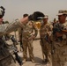 Iraqi soldiers plan a patrol through Abu Ghraib