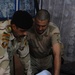 Iraqi soldiers plan a patrol through Abu Ghraib