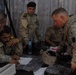 Iraqi soldiers plan a patrol through Abu Ghraib