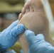 Soldier cleans fellow Soldier's feet