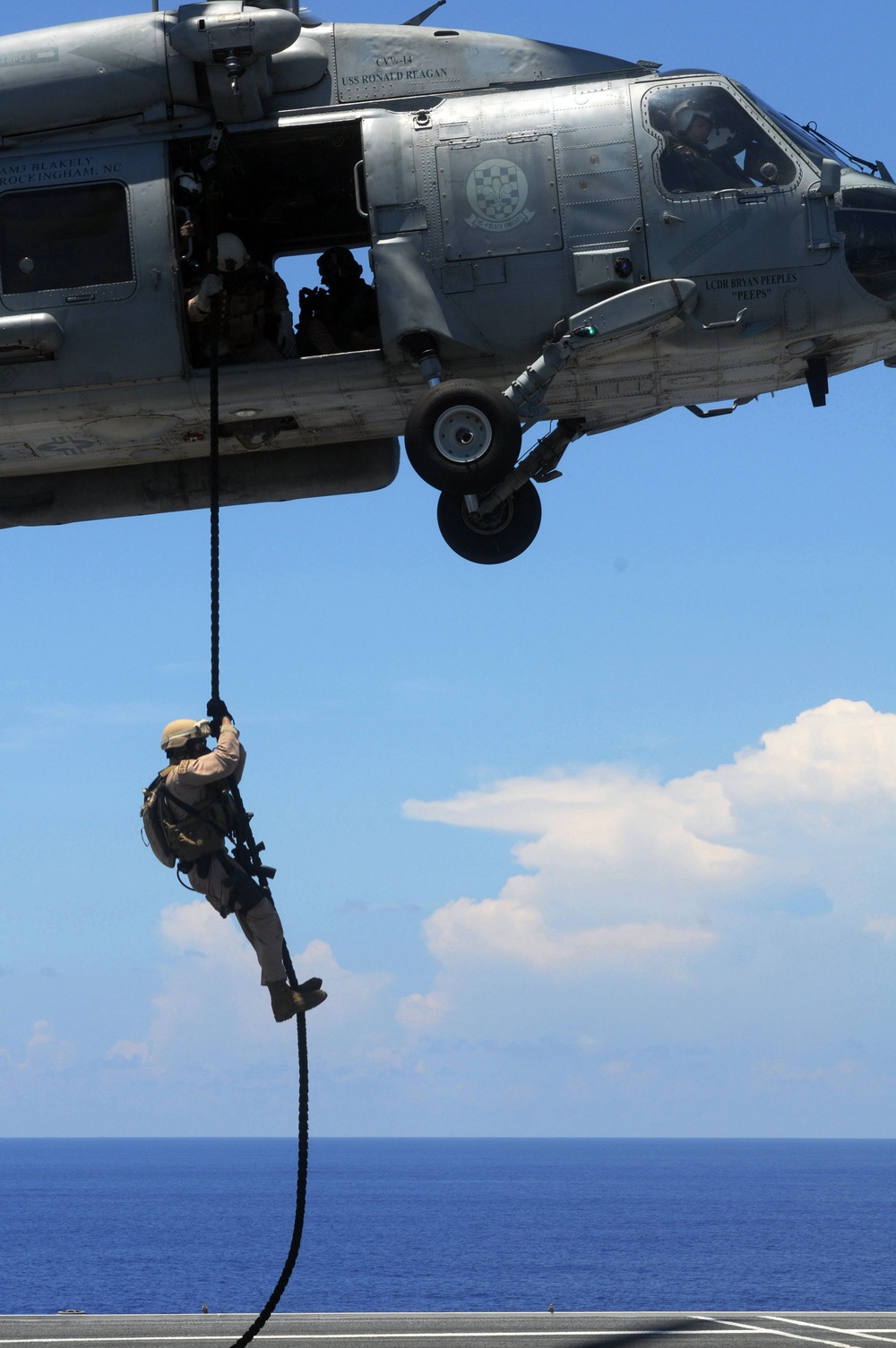 Explosive ordnance disposal fast ropes into action