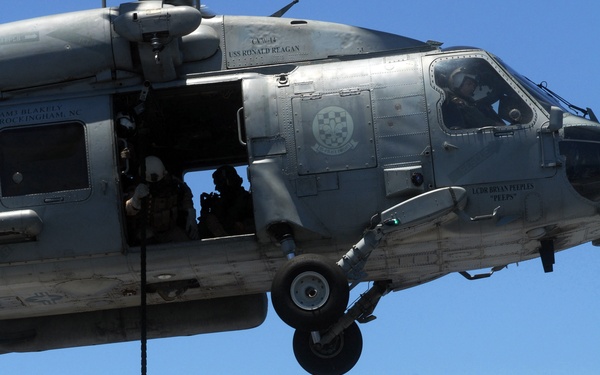 Explosive ordnance disposal fast ropes into action