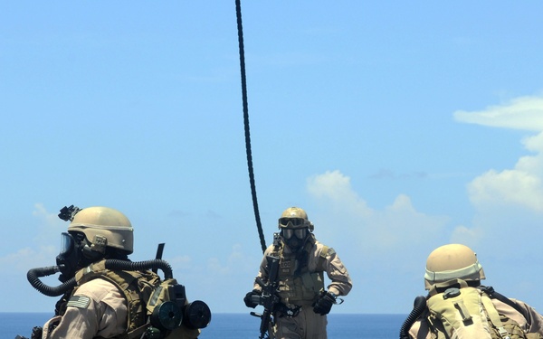 Explosive ordnance disposal fast ropes into action