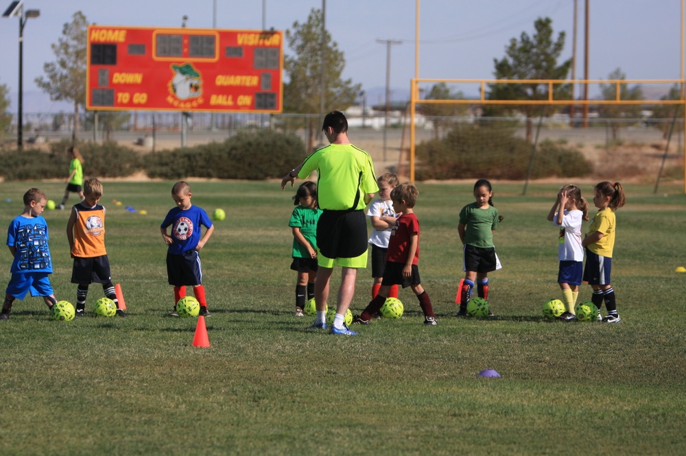 British Soccer Camp coaches show Combat Center children skills, sportsmanship