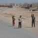 Iraqi children greet passing Marine patrol