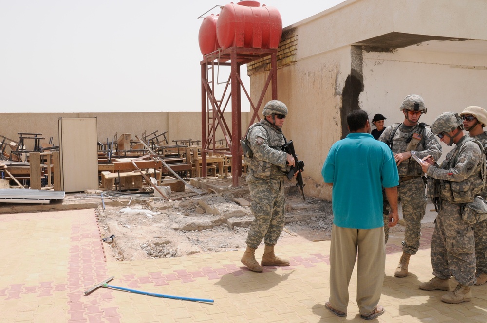 Soldier's help refurbish school