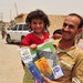 Soldiers Hand Out School Supplies