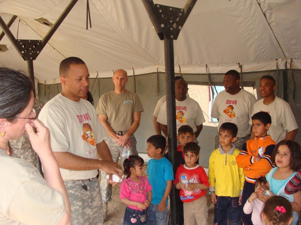 A unique call to duty: Fraternity &quot;brothers in arms&quot; give to Soldiers and Iraqi children
