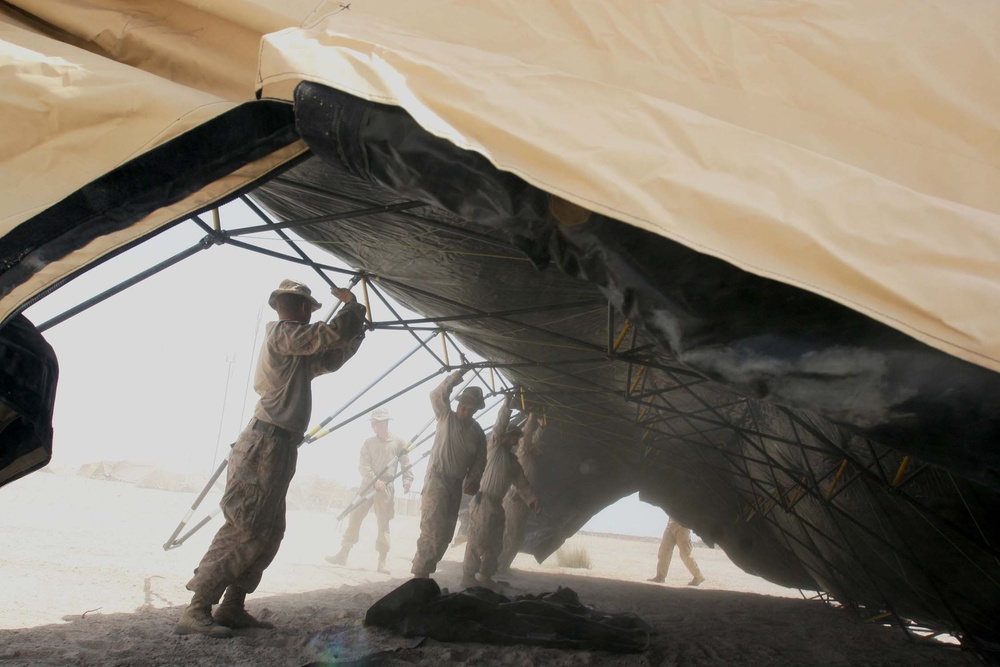 Marines build tents in Afghan firebase