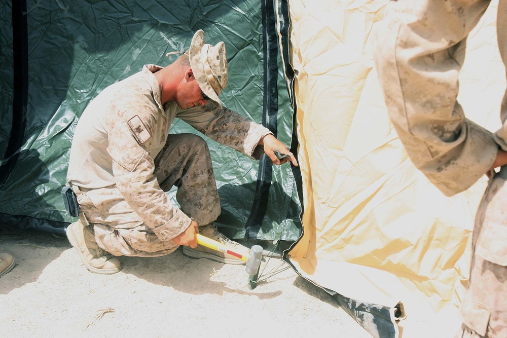 Marines build tents in Afghan firebase