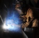 Kuwait-deployed service members dig and weld