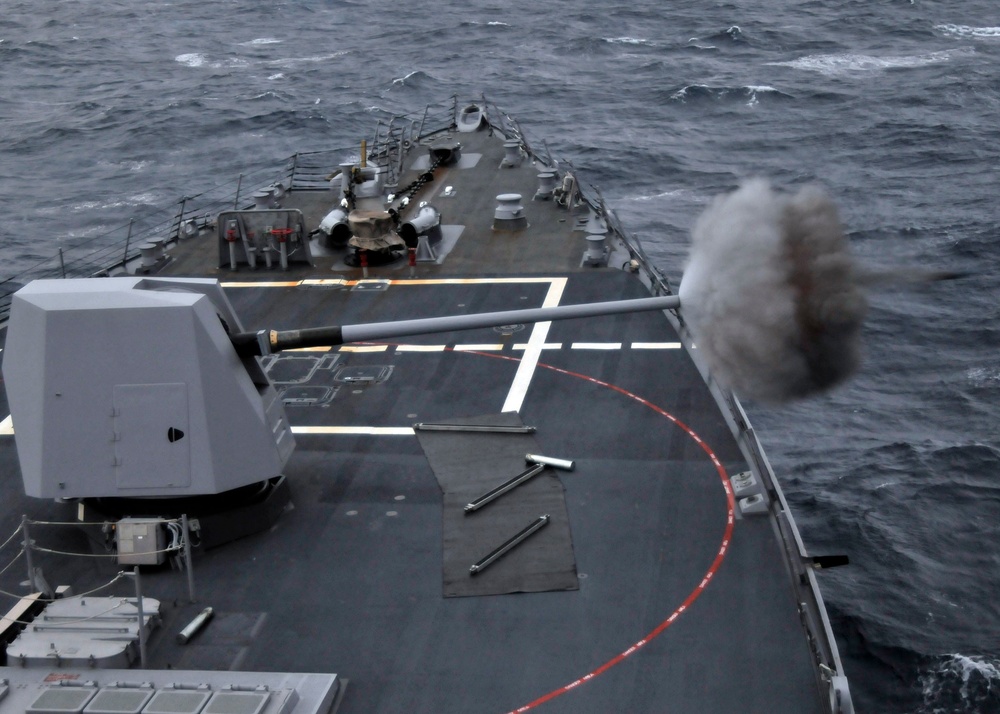 USS Mustin prepares to fire deck gun