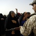 U.S., Iraqi soldiers hand out food