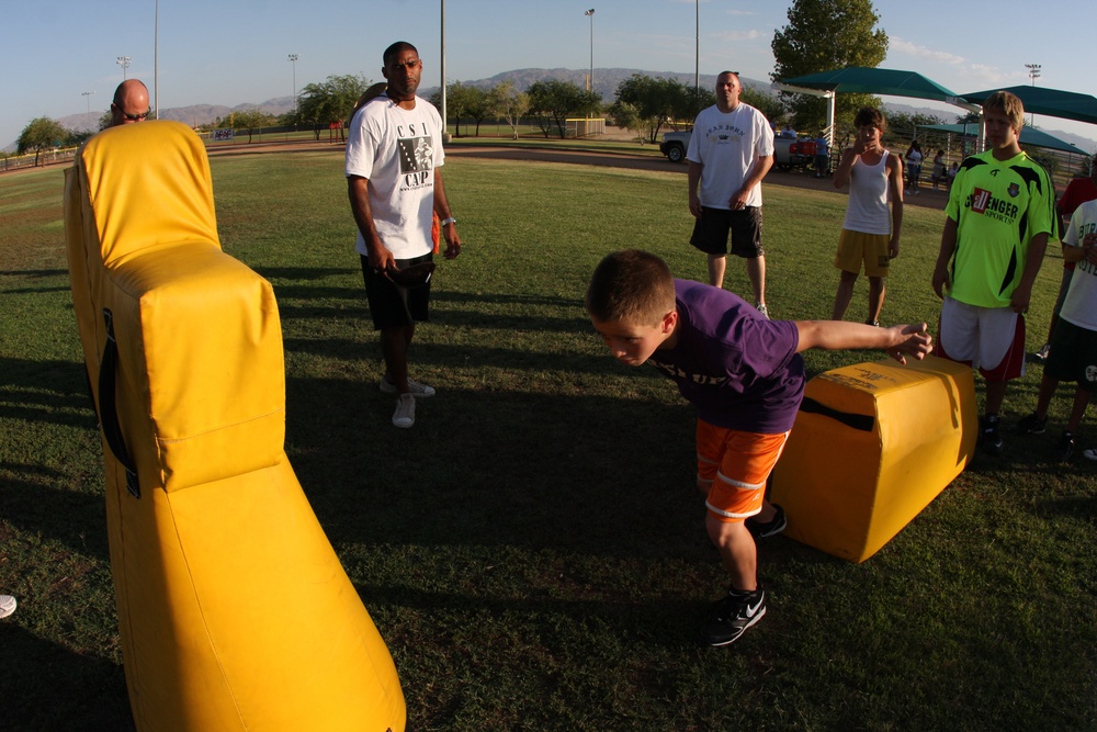 Former Super Bowl champion teaches football to Combat Center kids