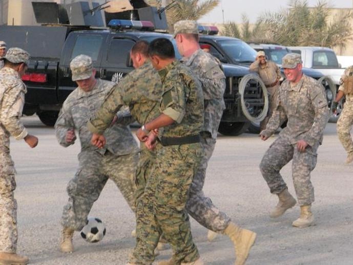 Iraqi, U.S. Soldiers pass the ball and pass some time
