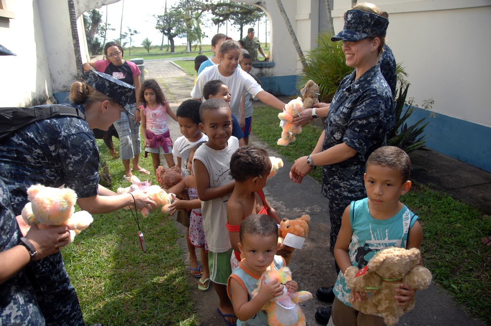 Handing out Teddy Bears to Children
