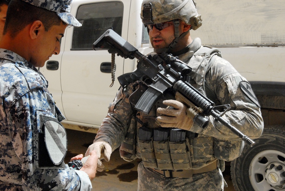 A pair of protective rubber gloves mark the place, Sunday June 29, 2003,  where the remains of two missing soldiers were found 32 kilometers (20  miles) northwest of Baghdad on Saturday. Sgt.