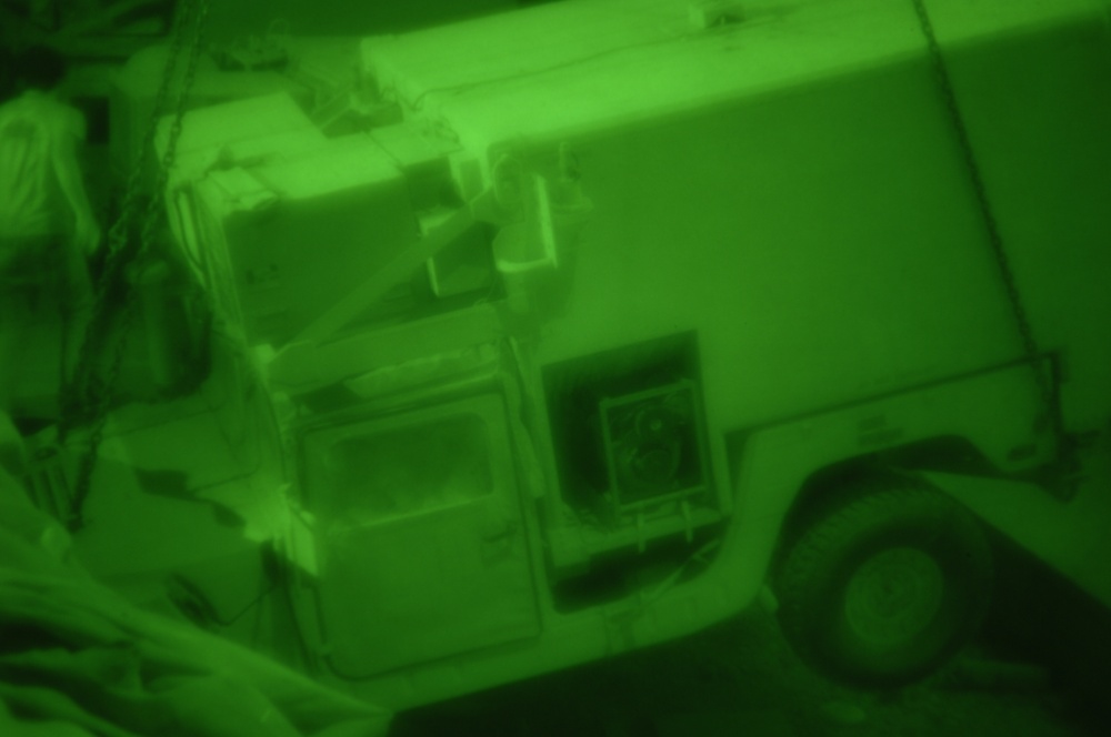 U.S. troops lift Humvee from hole