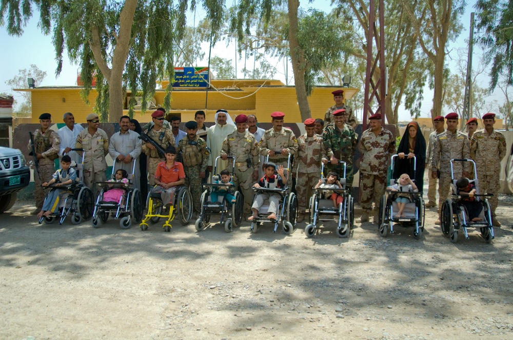 U.S. Soldiers, civilians deliver wheelchairs to Iraqi children in need.