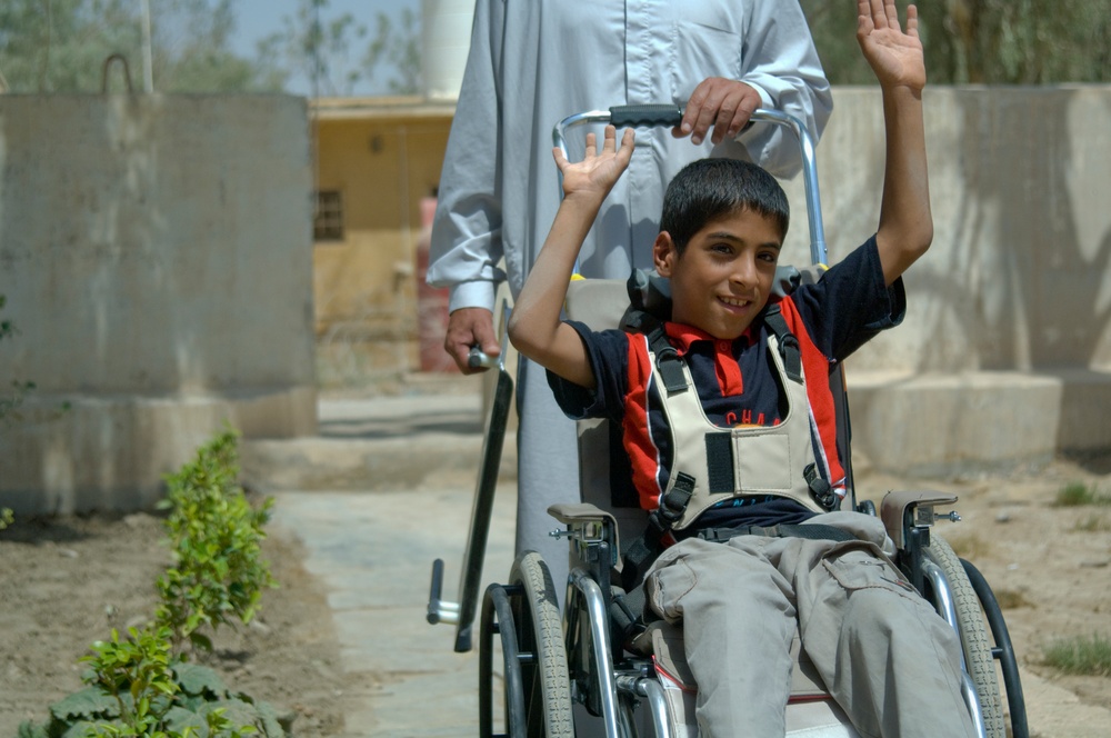 U.S. Soldiers, civilians deliver wheelchairs to Iraqi children in need.